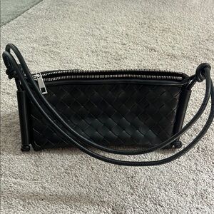 Never used. Small black shoulder bag. Woven foe leather.